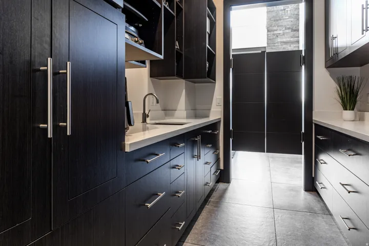 Butler's Pantry Custom dark wood-finish cabinetry featuring brushed nickel hardware