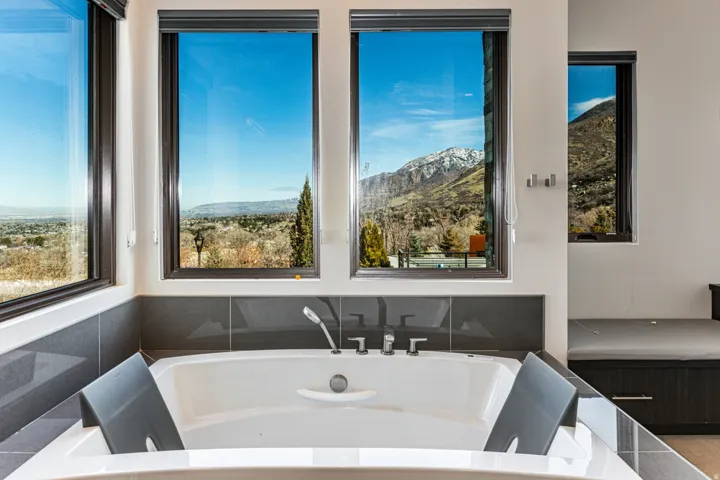 Master Soaking tub featuring polished chrome fixtures and a handheld shower