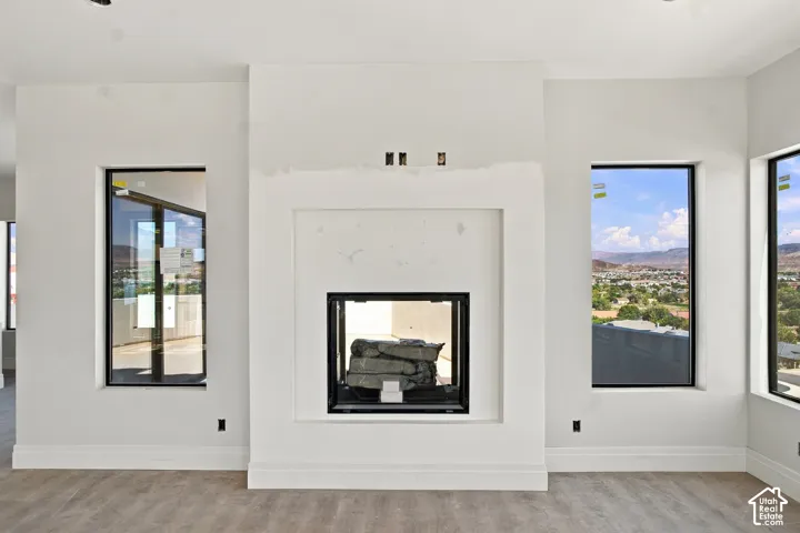 Modern fireplace with a black firebox, white surround, and integrated mantle