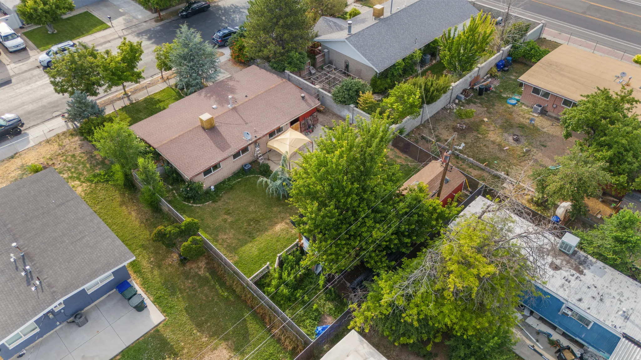 Residential property featuring a brown shingle roof, light brick exterior, and a green lawn