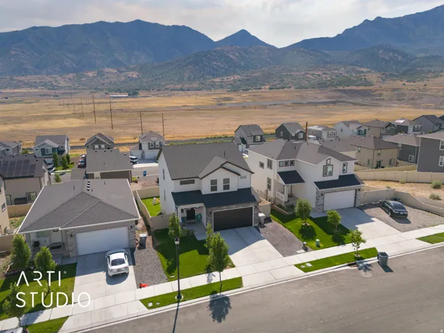 Modern two-story residence featuring a two-car garage, stone and siding exterior, and landscaped front yard