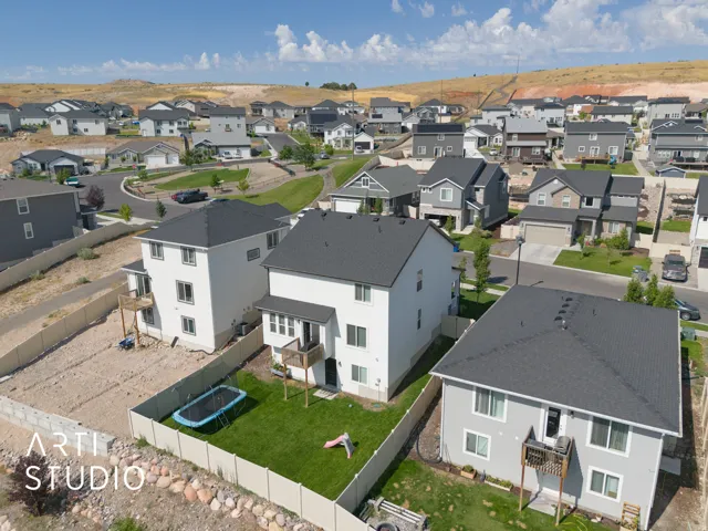 Aerial view of a residential neighborhood featuring modern homes with dark roofs