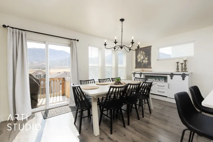 Open concept dining area featuring wood-finish flooring and a contemporary chandelier