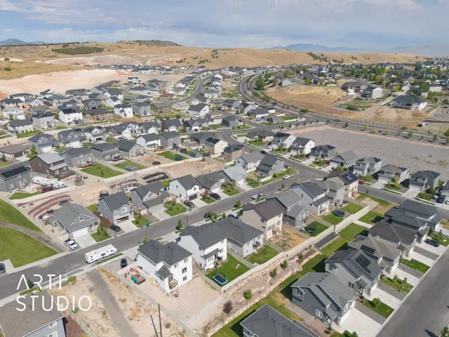 Expansive suburban development featuring a variety of single-family homes with pitched roofs and manicured lawns