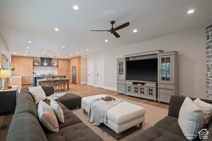 Open-concept great room designed for everyday living, with multiple lighting zones that create distinct yet connected areas for relaxing and entertaining