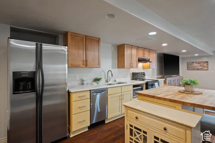 Complete basement kitchen with a freestanding, removable island that provides flexibility for food preparation, dining, or additional workspace.