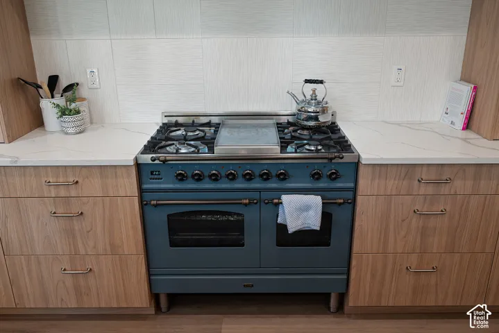 High end Italian ILVE Nostalgie 40" dual-fuel range featuring double ovens, rotisserie capability, and a removable stainless-steel griddle that can be replaced with six gas burners.