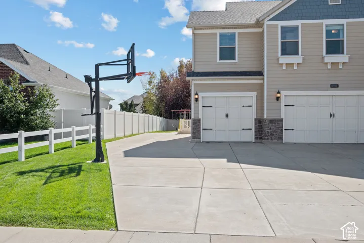 Generous off-street parking accommodates 7+ vehicles, with the third garage bay offering the flexibility to function separately from the main garage.
