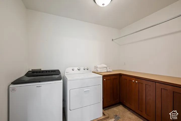 Conveniently located second-floor laundry near the bedrooms, with substantial wood cabinetry keeping laundry supplies organized and within easy reach.62