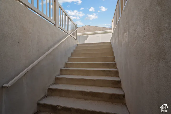 Wide double stairs provide convenient access to the side yard while also serving as a private secondary entrance to the walk-out basement.