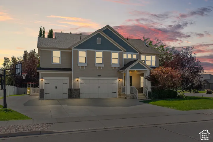 Twilight view showcasing the home's warm exterior lighting, Craftsman character, and inviting presence from the street.