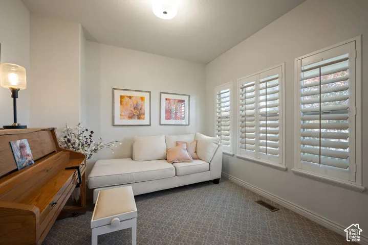 Bright front living room or office just off the entry, with plantation shutters that allow the space to feel open and light-filled.