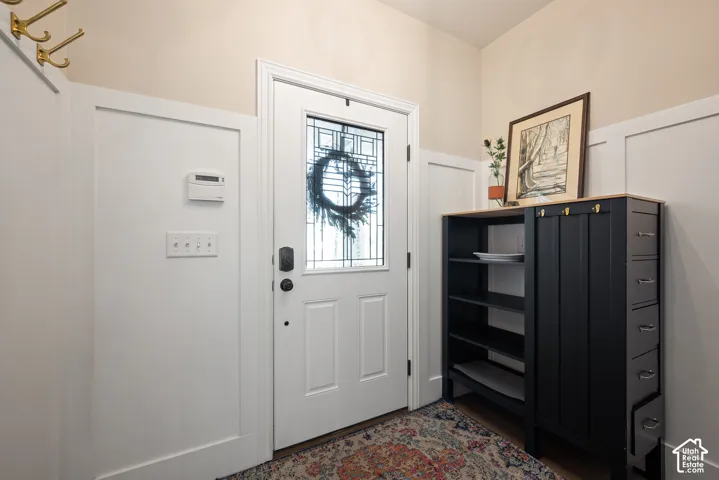 Welcome entry featuring tasteful two-tone wall trim, a beautiful stained-glass front door that creates a defined entry.