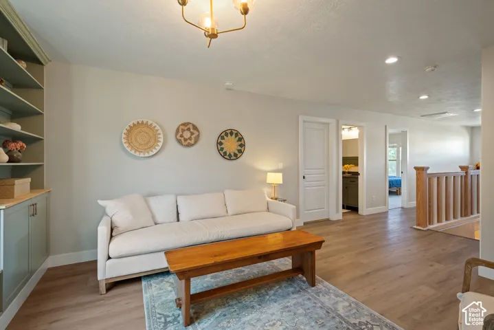 Wide second-floor hallway finished with luxury vinyl plank flooring and a custom Craftsman-inspired modern oak railing.