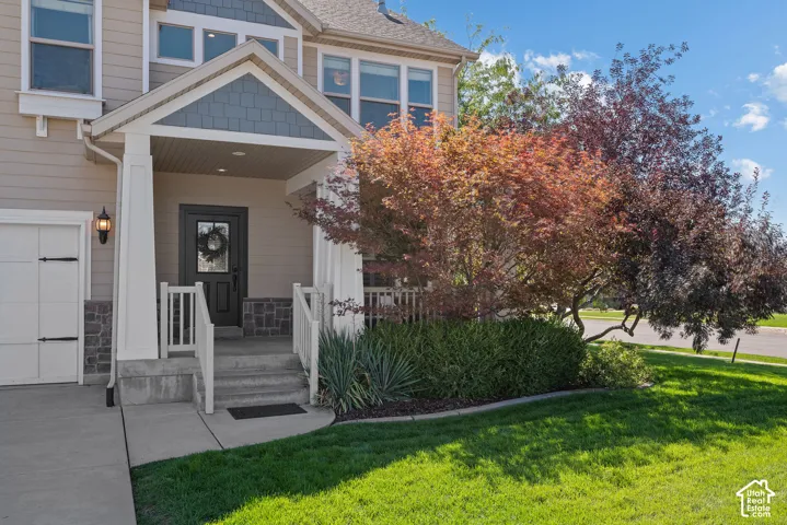 Distinctive Craftsman character with durable Hardie board, partial stone siding and a covered, pillared entry that creates a warm and inviting first impression.