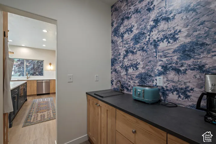 Butler's pantry with a secondary bar sink and flexible storage, including room to add additional shelving as needed.