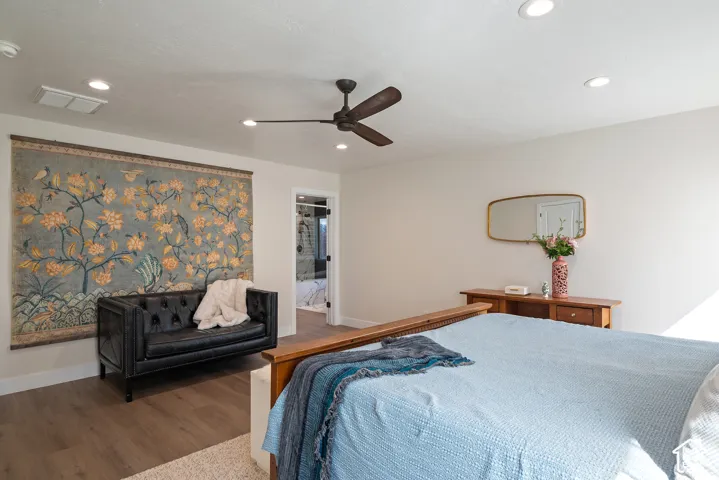 The primary suite offers room for a comfortable seating area in addition to the bedroom furnishings, creating a relaxing retreat within the home.