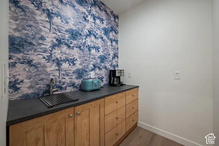 A modern butler's pantry keeps everyday appliances accessible while tucked neatly out of sight, with a combination of drawers and cabinetry for organized storage.