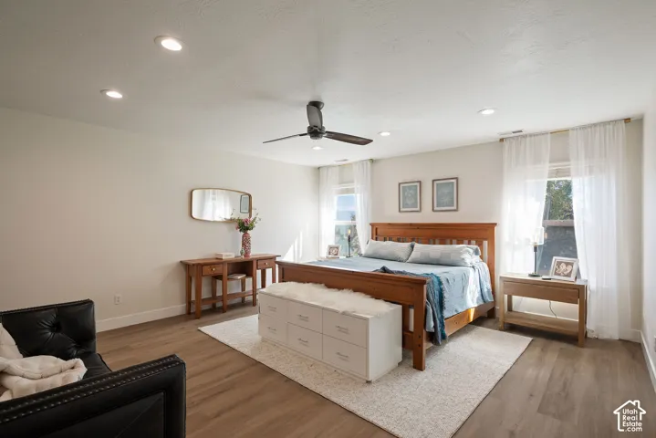 Private primary suite tucked away on the second floor, featuring continuous luxury plank flooring and two symmetrical windows.