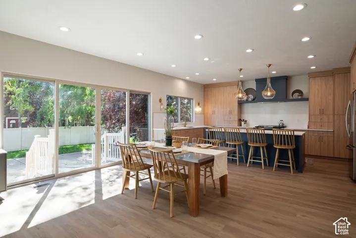 Dining and kitchen area framed by a wall of windows, filling the home with natural light and showcasing the generous, thoughtfully designed kitchen layout.