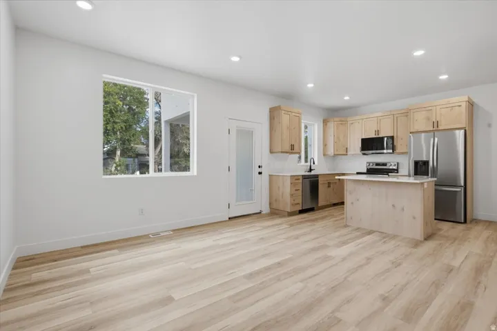 Living room and Kitchen.  Door to covered patio.
