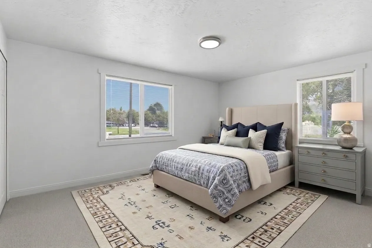 Room featuring light-colored walls, recessed lighting, and carpeted flooring
