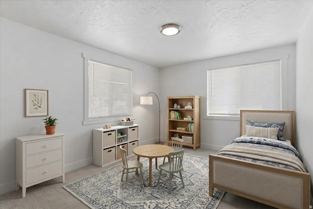 Bright room featuring two windows with white blinds, neutral carpeting, and a flush-mount ceiling light fixture