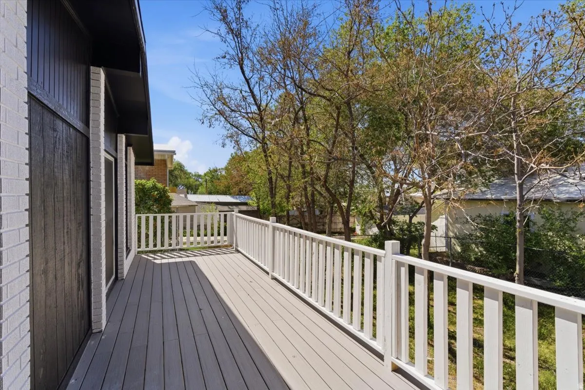 Spacious outdoor deck with composite wood-finish flooring and white picket railing