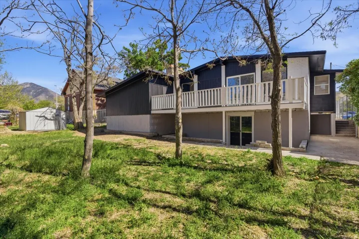 Multi-level exterior with dark siding and white trim