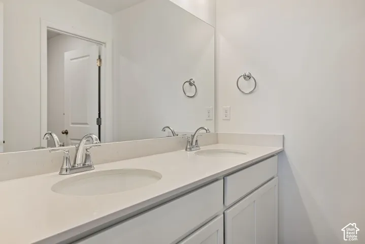 Check out this secondary bath with dual-vanities and a door separating a bathtub/shower and toilet!