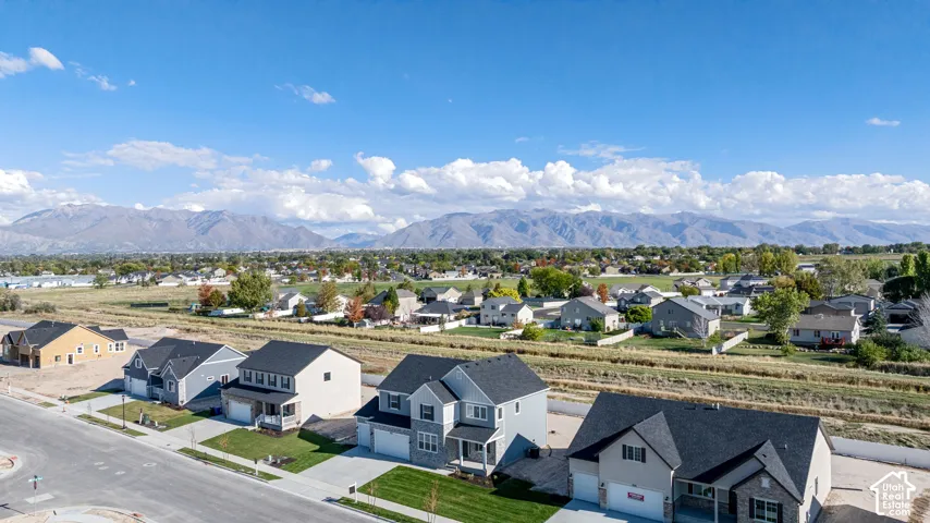 Aerial view of our new subdivision with a stunning expansive mountain range backdrop.
