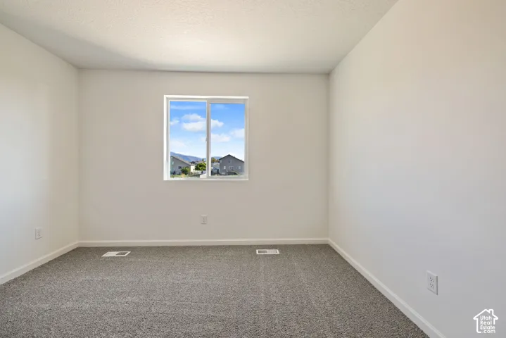 Large bedroom with a view of the back yard and a walk in closet. (One of two secondary bedrooms).