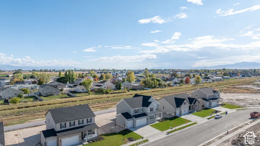 Aerial view of our new subdivision with a stunning expansive mountain range backdrop.