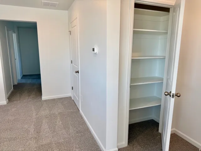 Adjacent to the Loft, just at the top of the stairs and near the Primary bedroom is a linen closet and utility room right past that.