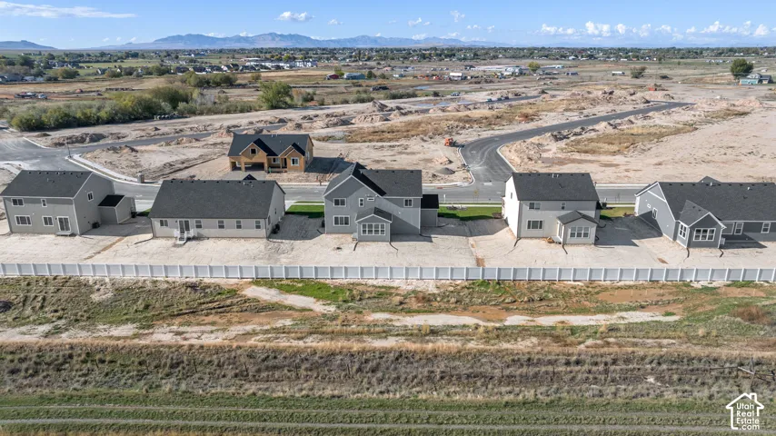 Aerial view of the back yard of this subdivision with a stunning, expansive views. There will be no direct back yard neighbors ever as there will be a 20 ft wide greenspace behind the homes and a two-lane road (similar to the one in front of these homes)