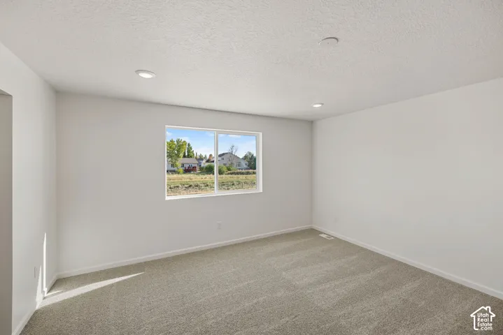 The Primary bedroom is large enough to easily fit a king-sized bed and furniture with natural sunlight and beautiful views out the window.