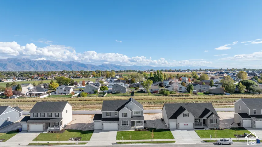 Aerial view of our new subdivision with a stunning expansive mountain range backdrop.
