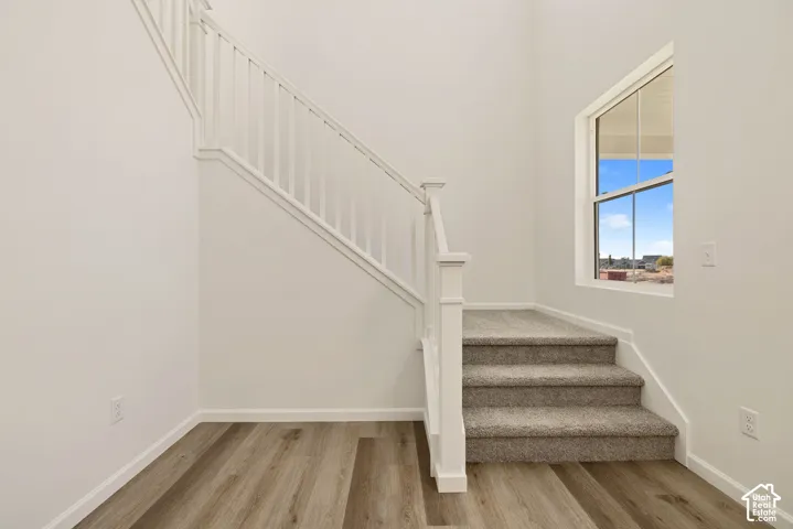 A GRAND front entry greets you with ceilings vaulted to the 2nd floor and an open staircase surrounding the perfect place to decorate for the Holidays! There is LOADS of storage space under the stairs as well as access to the "Crawl Space" that is about