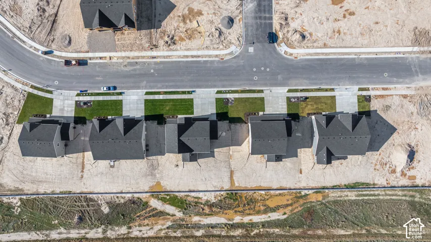 Aerial view of the back yard of this subdivision with a stunning, expansive views. There will be no direct back yard neighbors ever as there will be a 20 ft wide greenspace behind the homes and a two-lane road (similar to the one in front of these homes)
