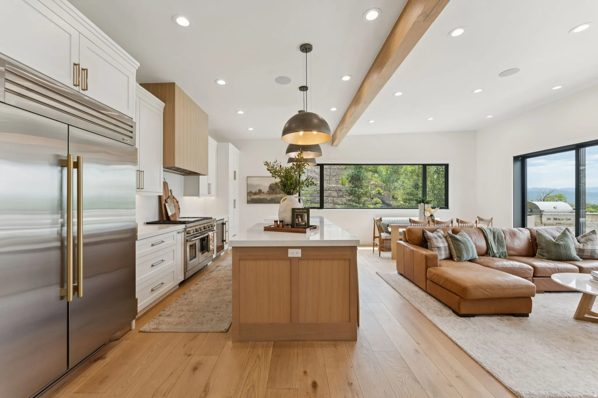 Open-concept living space with light wood-finish flooring