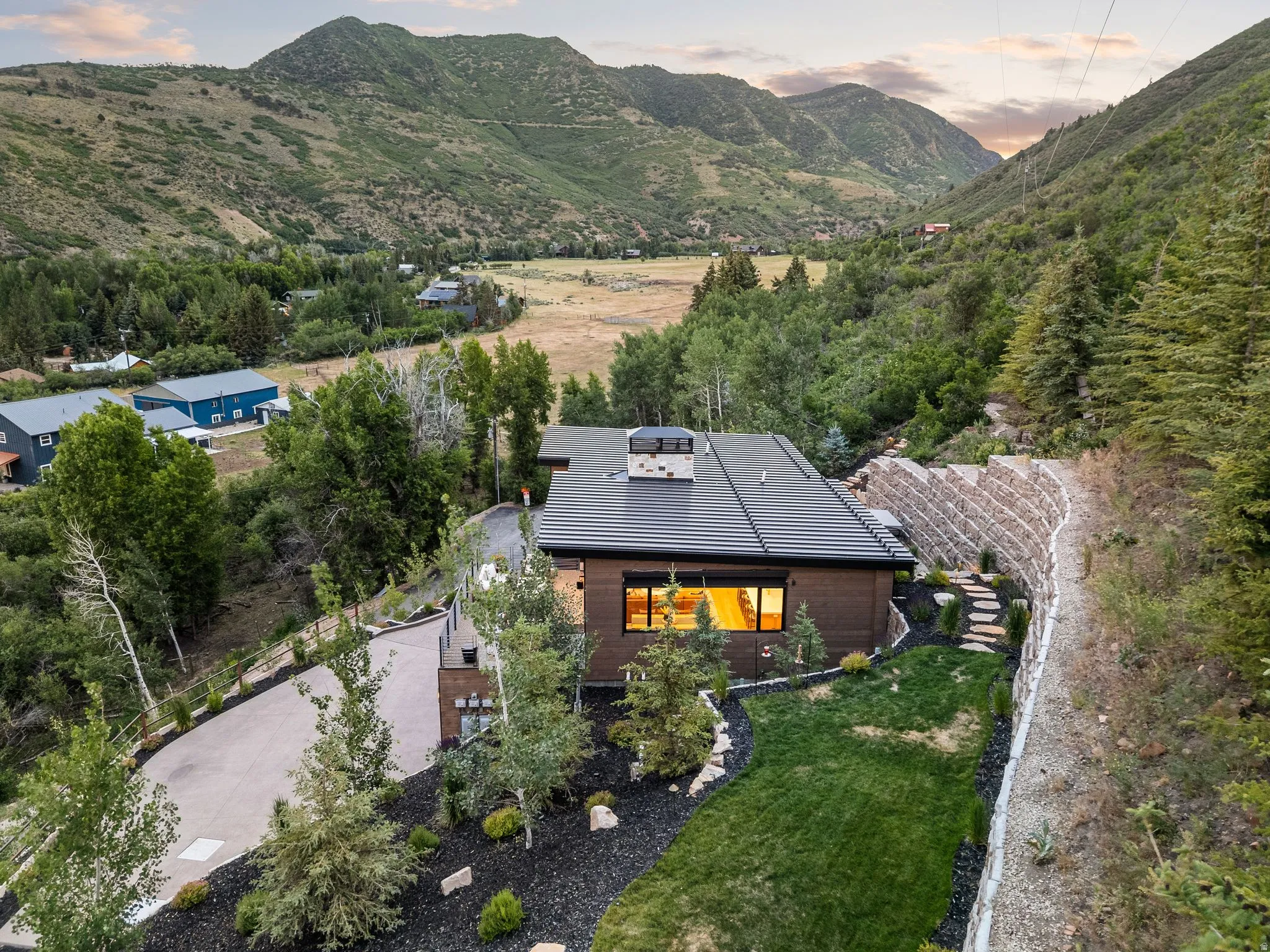 Modern architectural residence featuring a dark-toned exterior and a dark-pitched roof