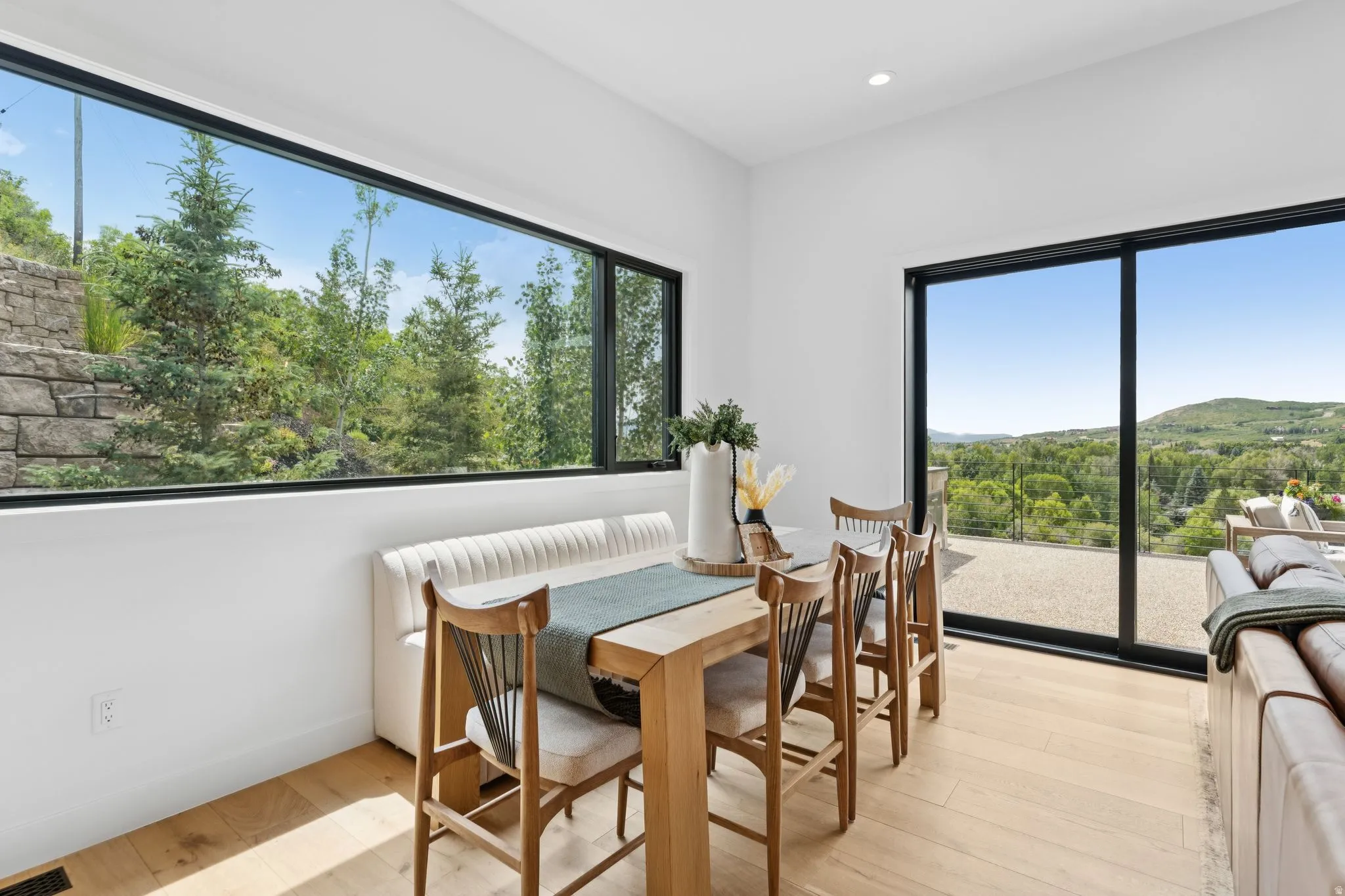 Expansive dining area featuring a wide panoramic window and a large sliding glass door