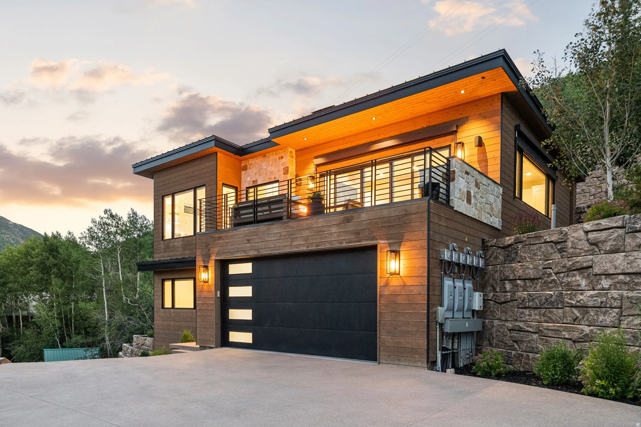 Modern facade featuring wood-finish siding and stone accents
