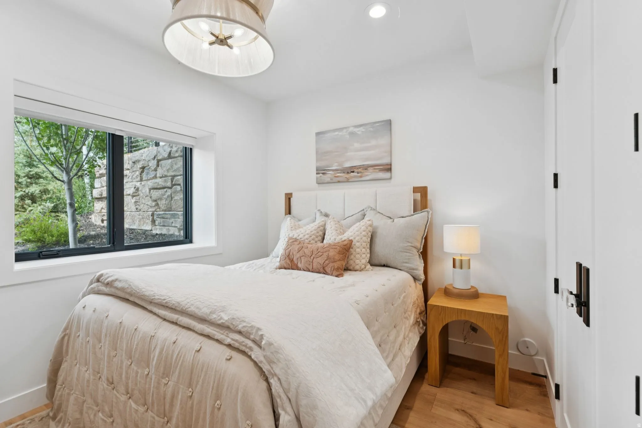 Bright room featuring a large window, recessed lighting, and wood-finish flooring