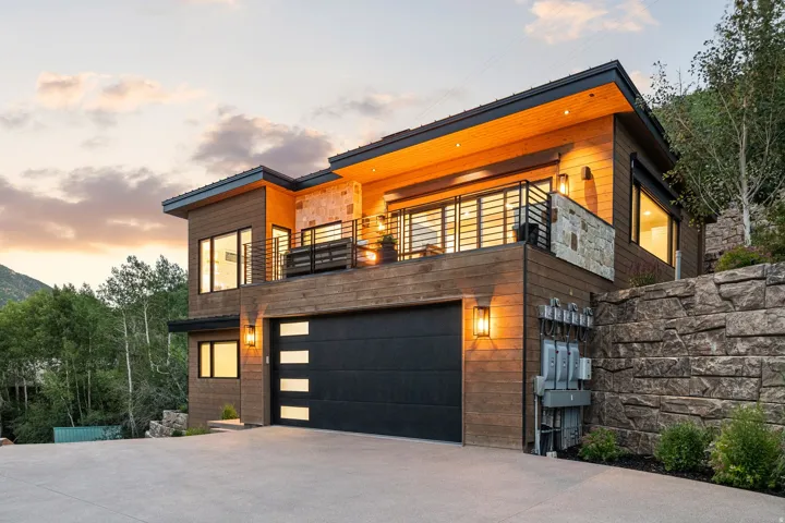 Modern facade featuring wood-finish siding and stone accents