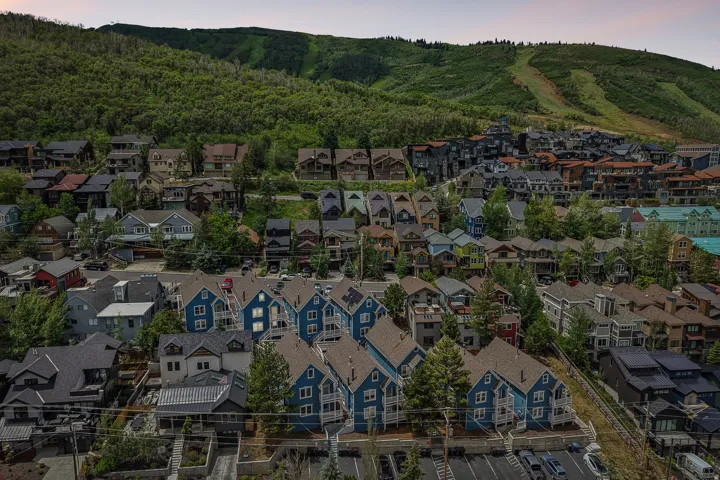 Residential community at the base of a forested mountain