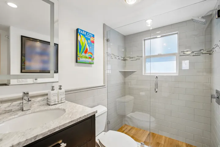 Bathroom featuring a dark wood vanity with a white marble countertop and integrated sink