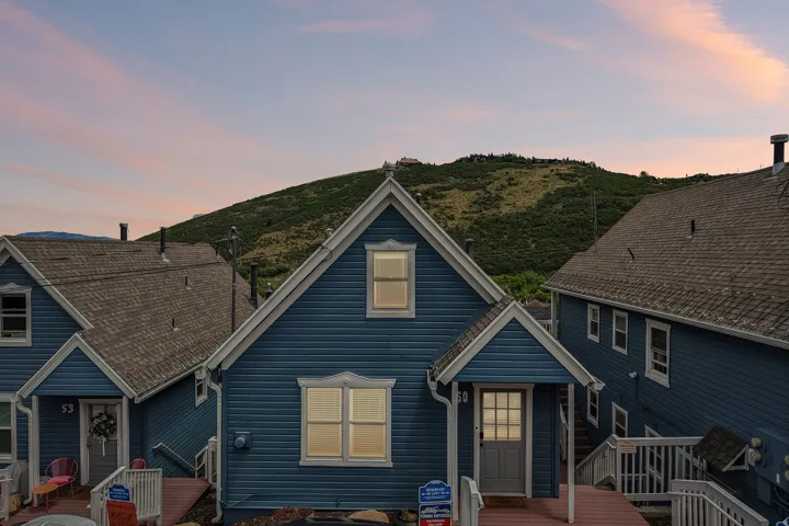 Blue siding exterior with white trim, featuring a prominent front gable
