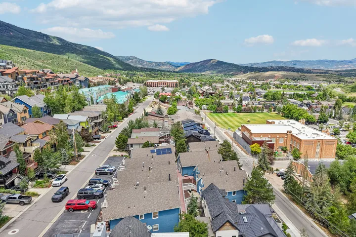 Aerial perspective of a developed mountain community with varied residential architecture