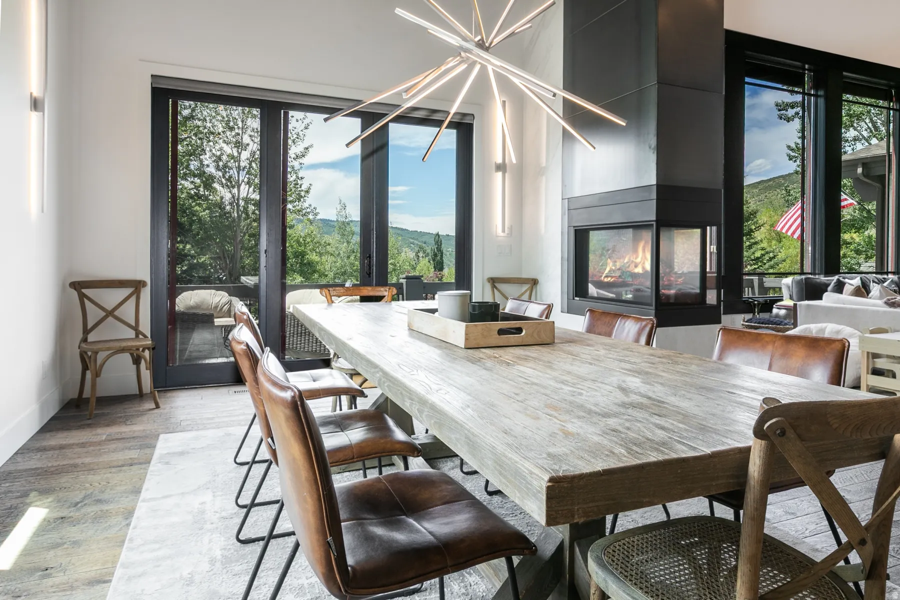Spacious dining area featuring a prominent corner fireplace with a dark metal surround